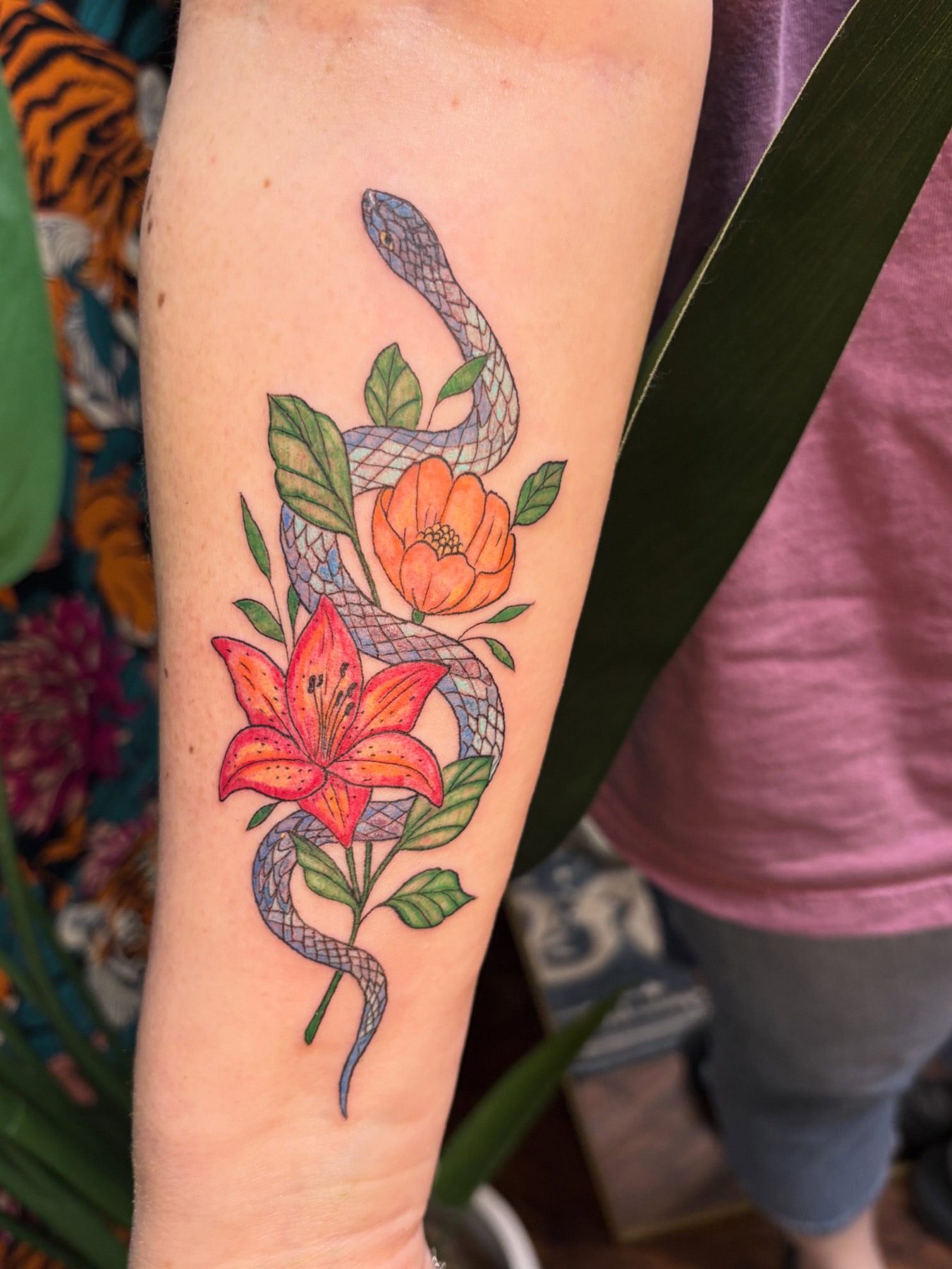 Colorful floral and snake tattoo by Boundaries Tattoos